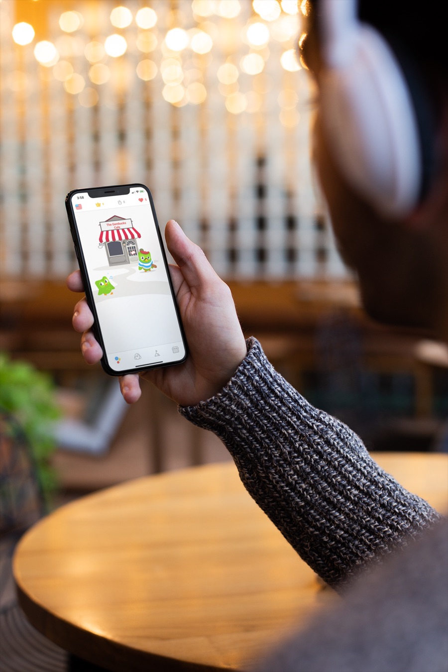 A phone in someone's hand showing a DuoVillage conversation